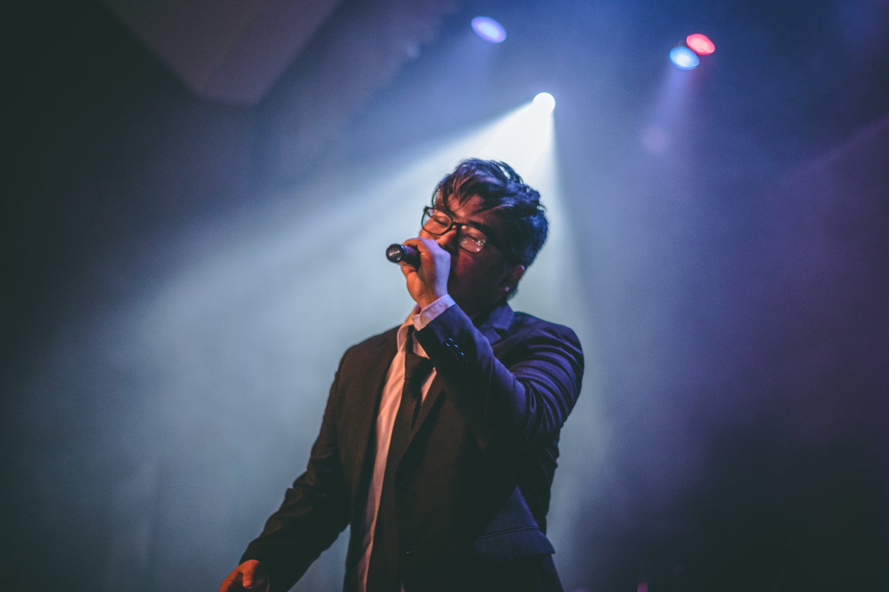 Man Holding Microphone on Stage